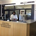 a photo of students at OIT desk
